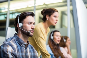 serious-male-customer-service-executive-working-desk